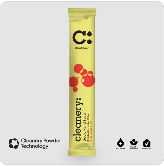 A single stick pack of Cleanery Liquid Hand Soap in Blood Orange & Mint flavor, featuring a bright yellow wrapper with red bubble graphics and a black logo, centered on a light gray background. Additional text at the bottom highlights 'Cleanery Powder Technology' and product features.
